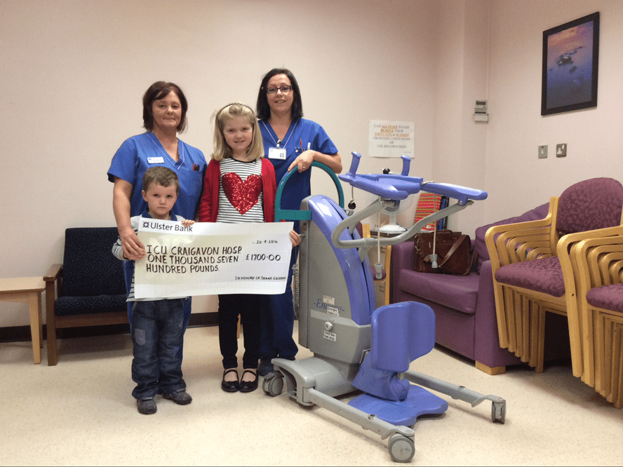 Orla McConville and Daniel Gribben the niece and nephew of Shane Gribben are pictured presenting their cheque to purchase a Patient Hoist in his memory to Staff Nurse, Ruth McParland and Sister Siobhan Jaztal from the Intensive Care Unit at Craigavon Area Hospital.