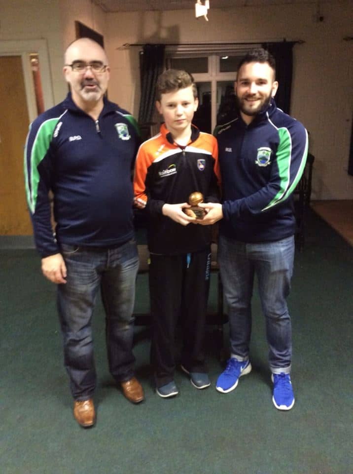 Dara O'Callaghan receives his U14 Most Committed Player of the Year award from Brendy Osborne and Micheál Brady.