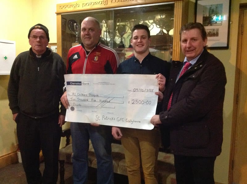 Father Kevin Cullen, Gary McKeown and Kevin Hoey of St. Patrick's GFC Cullyhanna were delighted to present of cheque worth £2500 to Martin Murphy representing Northern Ireland's Children's Hospice, following a successful fundraising event.