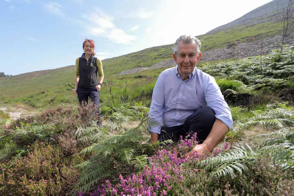 Minister Edwin Poots is pictured with Heather McLachlan, National Trust Director NI, at the site of the wildfire in the Mournes