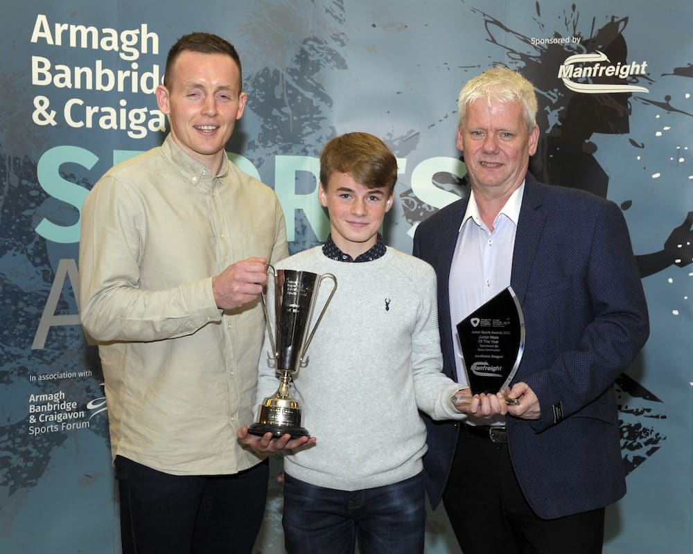 Lochlainn Beagan from Sean Doran Boxing Club, Keady wins the Junior Male Award sponsored by Moss Construction. Declan McKenna from Moss Construction and Seamus McGrath from Armagh, Banbridge and Craigavon Sports Forum present the award.