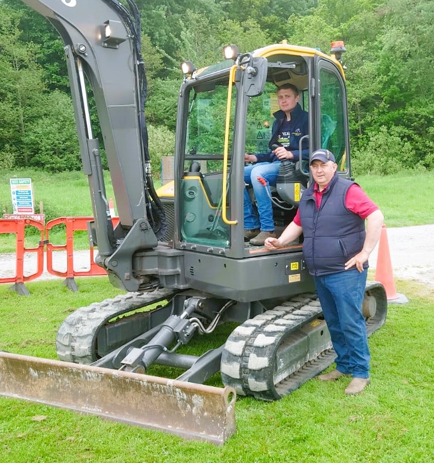 Barry Scott (standing) and Christopher Scott (in cab) who hosted their Digger Challenge which saw some great examples of precision skills
