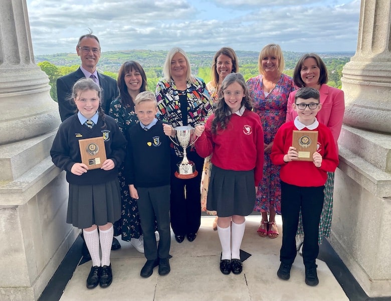 Pupils and staff from Carrick Primary School, Lurgan and Tullygally Primary School, Craigavon, are presented with the Derrytrasna pastoral care award by the Permanent Secretary of the Department of Education, Dr Mark Browne and Director of Public Health, Public Health Agency Dr Joanne McClean