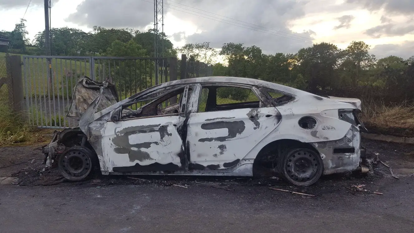 Burnt out car on Dundrum Road, Tassagh