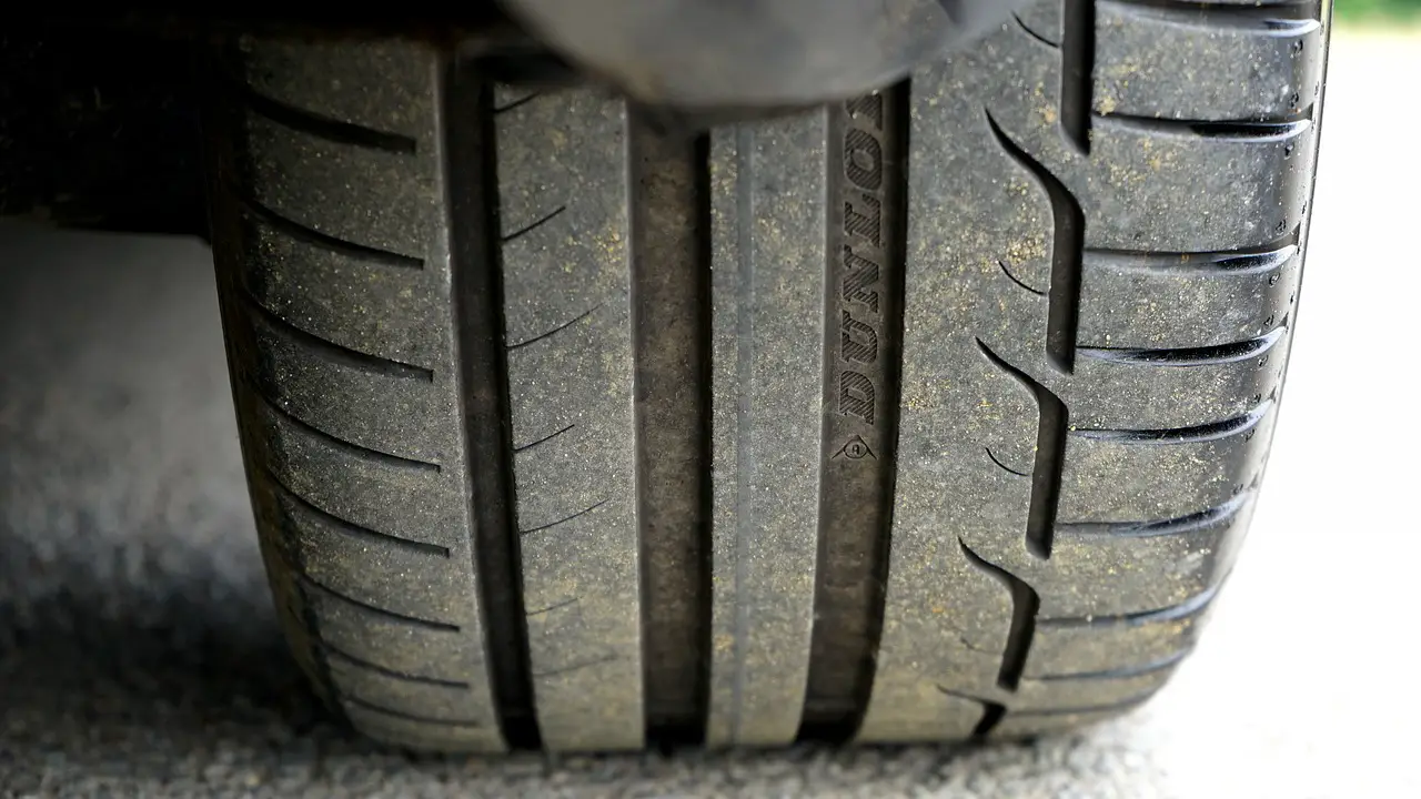 motorist-with-two-defective-tyres-checking-opening-times-of-garage-to