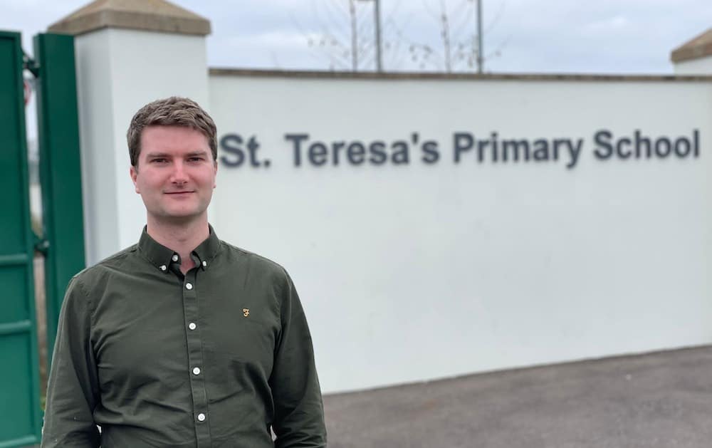 Alliance Councillor Peter Lavery outside St Teresa's Primary School