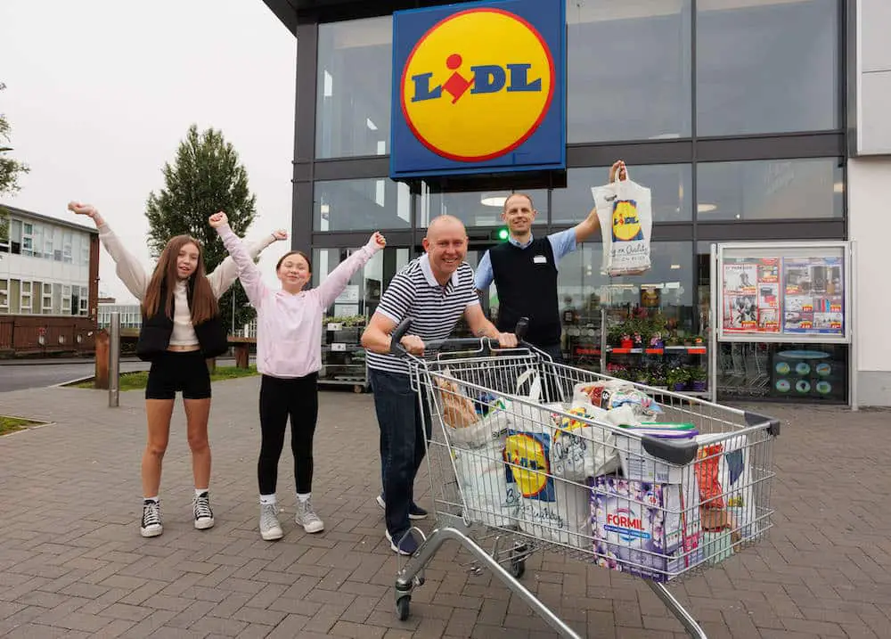 Lurgan Store Manager Simon Magowan with winner Brian McAclinden and daughter Maisy