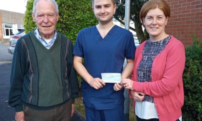 Vincent Lennon and daughter Fiona McKenna presenting a cheque to Dr Sherry of the Acute Care at Home Service.