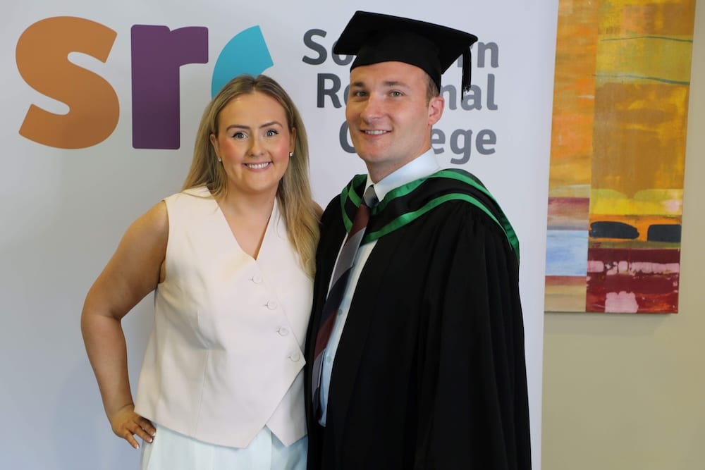 Declan Heaney at graduation alongside fiancée Orla.